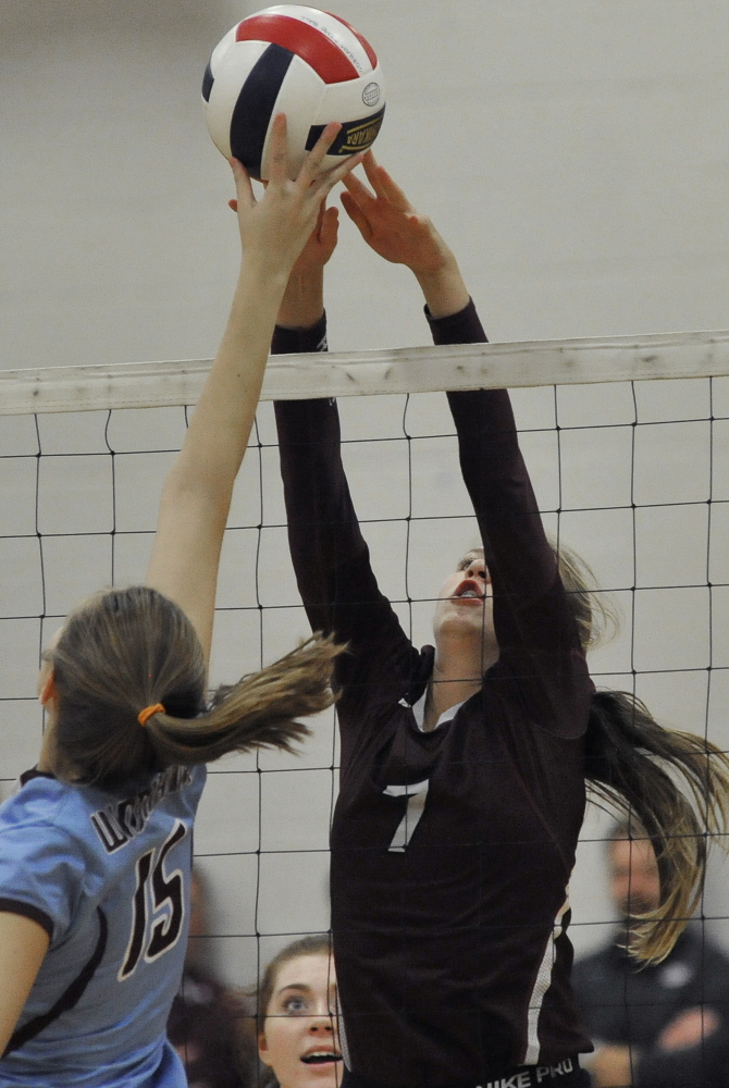 Diana Kolb of Gorham attempts to block a shot by Natalie Jeffrey of Windham during Gorham’s 3-1 victory Thursday night in a Class A volleyball prelim at Gorham High. The Rams will play at Greely next.