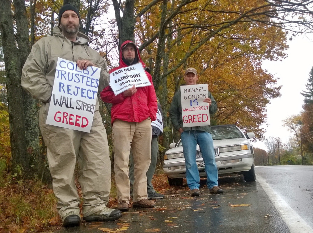 Striking FairPoint employee Lee Pettengill is joined by two others picketing a meeting of the Colby College trustees Friday in Waterville. A member of the Colby board, Michael Gordon, is chief investment officer for a New York investment firm that the union said owns a large stake in FairPoint.