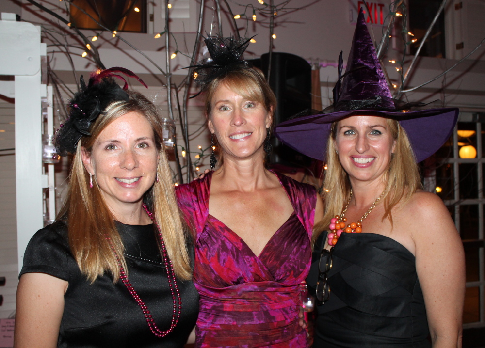 Sarah Abbott, left, of Falmouth and Mary Hanifin, right, both Witches Wear Pink committee members, flank JoAnne Christman, president and founder of the event.