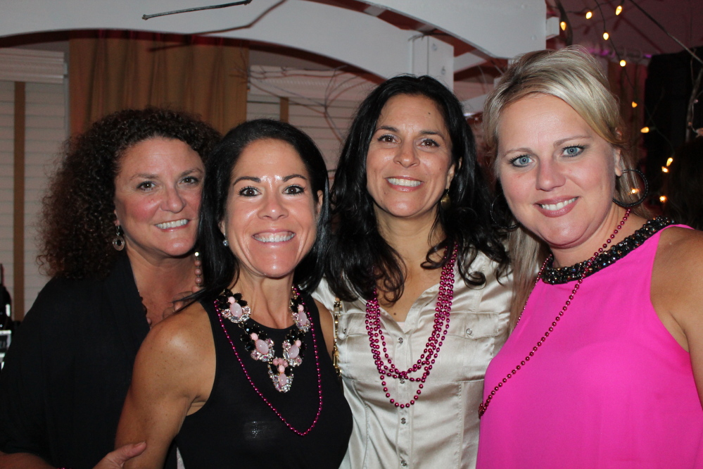 Sue Theriault, left, Christina McCluskey, Ann Dilworth and Lisa Severino, all of Falmouth, turn out to support cancer research at the fundraiser at The Woodlands Club in Falmouth.