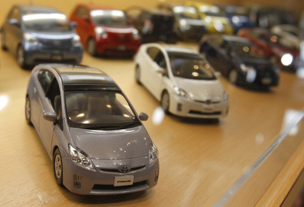 Replicas of Toyota Prius hybrids are displayed at a Tokyo showroom. Less than 4 percent of all vehicles sold last year were hybrids, and most of those were Priuses.