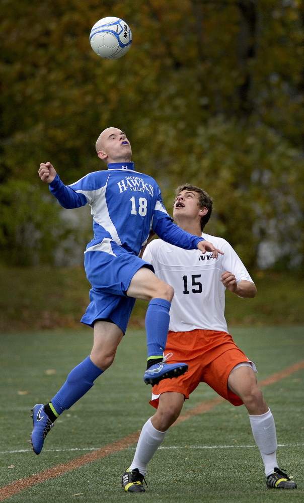Sacopee Valley’s Eli Moulton goes up for the ball over Sam Johnson of North Yarmouth Academy during Friday’s prelim.