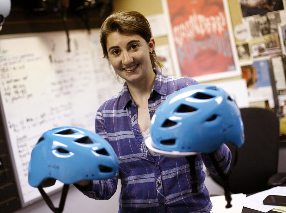 Emily Connors, assistant product manager for Bern Unlimited, shows a new helmet color in Kingston, Mass.