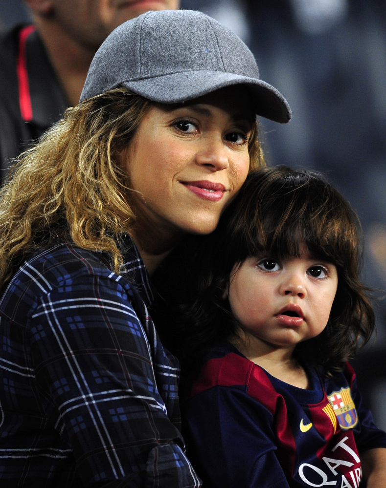 Shakira, left, holds her son, Milan. The singer’s toy line will benefit charity.
