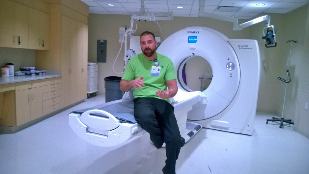 CAT scan coordinator Seth Hebert explains the new low-radiation CAT-scan machine at the Thayer Center for Health in Waterville, which hosted an open house Saturday.