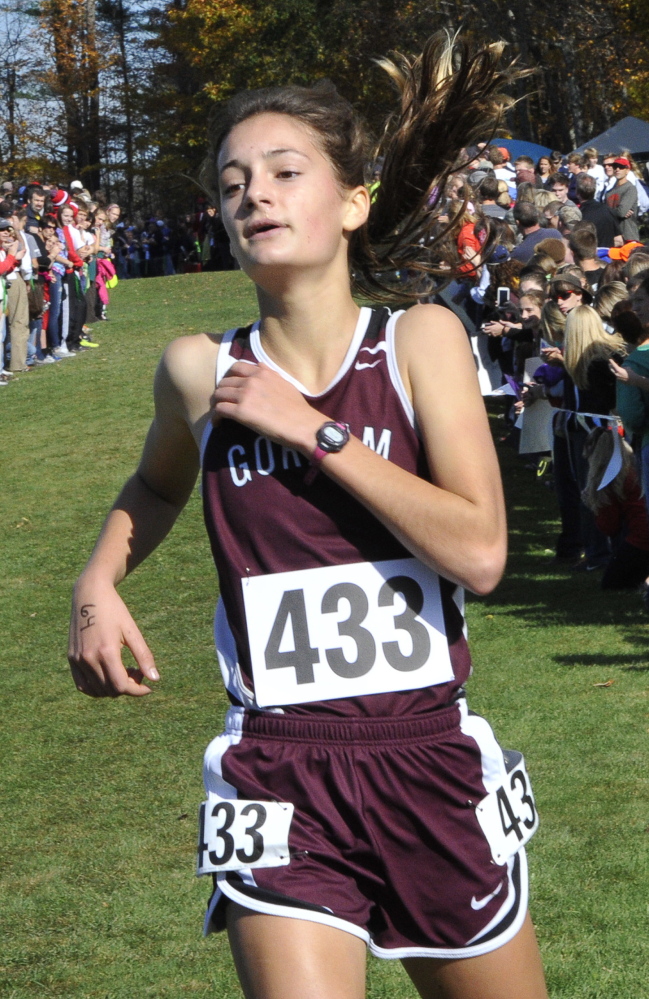 Anna Slager of Gorham crosses the finish line to win the Class A girls’ race with a time of 20 minutes, 4 seconds. Katherline Leggat-Barr posted the day’s best time – 19:46.76 – on her way to victory in Class B, and Hannah Austin of North Yarmouth Academy claimed the Class C title.