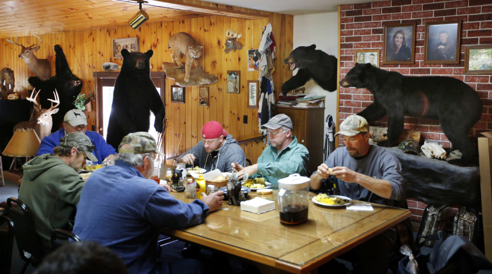 Out-of-state bear hunters eat a meal at the Stony Brook Outfitters lodge in Wilton. Maine voters will decide on a proposal to ban the use of bait, dogs, and traps to hunt black bears. If it passes, many outfitters say they’ll be out of business.