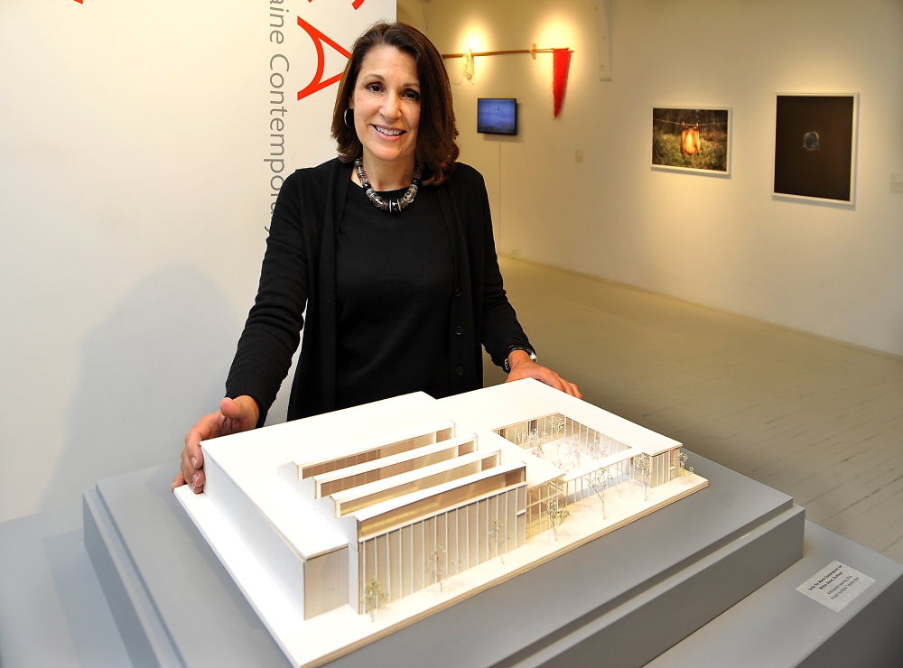 Director Suzette McAvoy of the Center for Maine Contemporary Art shows the model of the center’s new building in Rockland, designed by architect Toshiko Mori.
