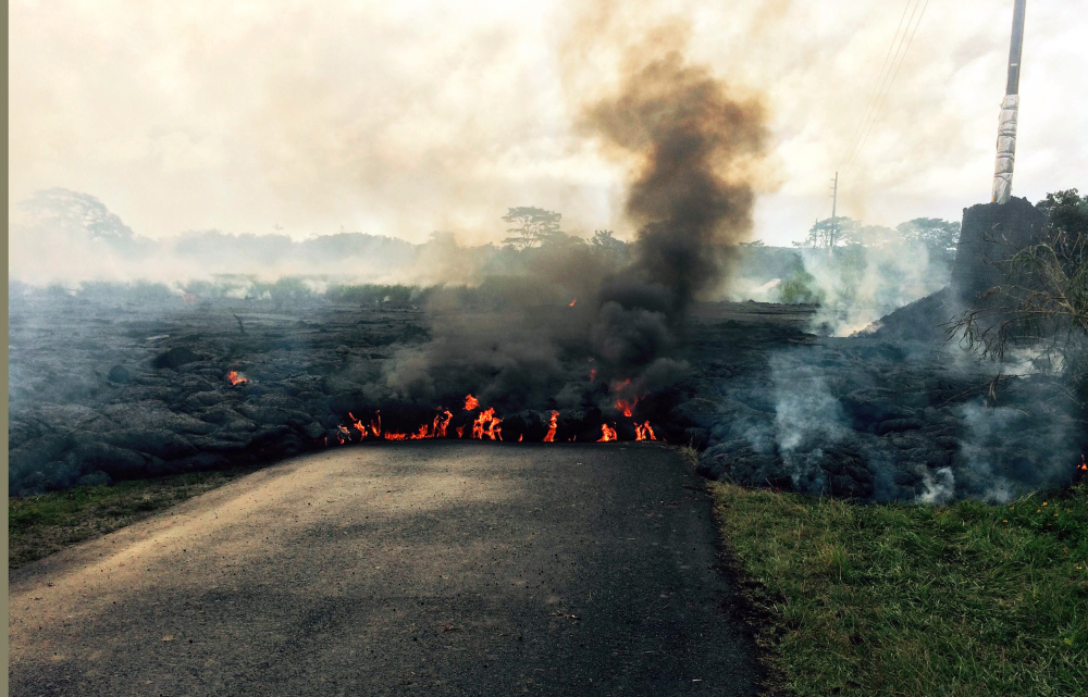 The lava flow from Kilauea volcano that began June 27 is seen crossing a street near the town of Pahoa on the island of Hawaii.