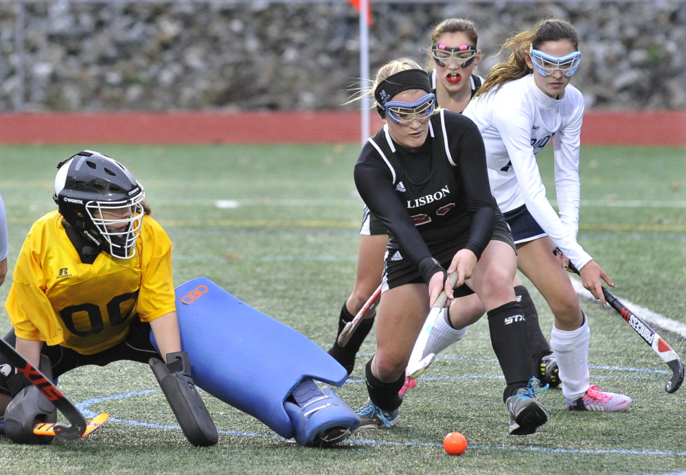 YARMOUTH, ME - OCTOBER 28: Lisbon's #28 Kate Philbrick scores her teams second goal past Yarmouth's goal keeper Tori Messina as Yarmouth HS field hockey hosts Lisbon for the Western Maine Class C field hockey semi-final. (Photo by John Patriquin/Staff Photographer)