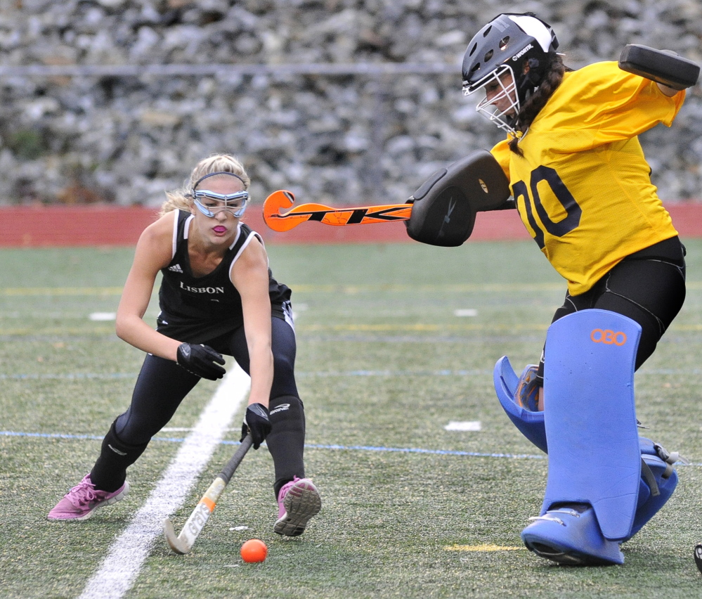 YARMOUTH, ME - OCTOBER 28: Yarmouth's goal keeper Tori Messina stops a shot from Lisbon's #11 Chase Collier as Yarmouth HS field hockey hosts Lisbon for the Western Maine Class C field hockey semi-final. (Photo by John Patriquin/Staff Photographer)