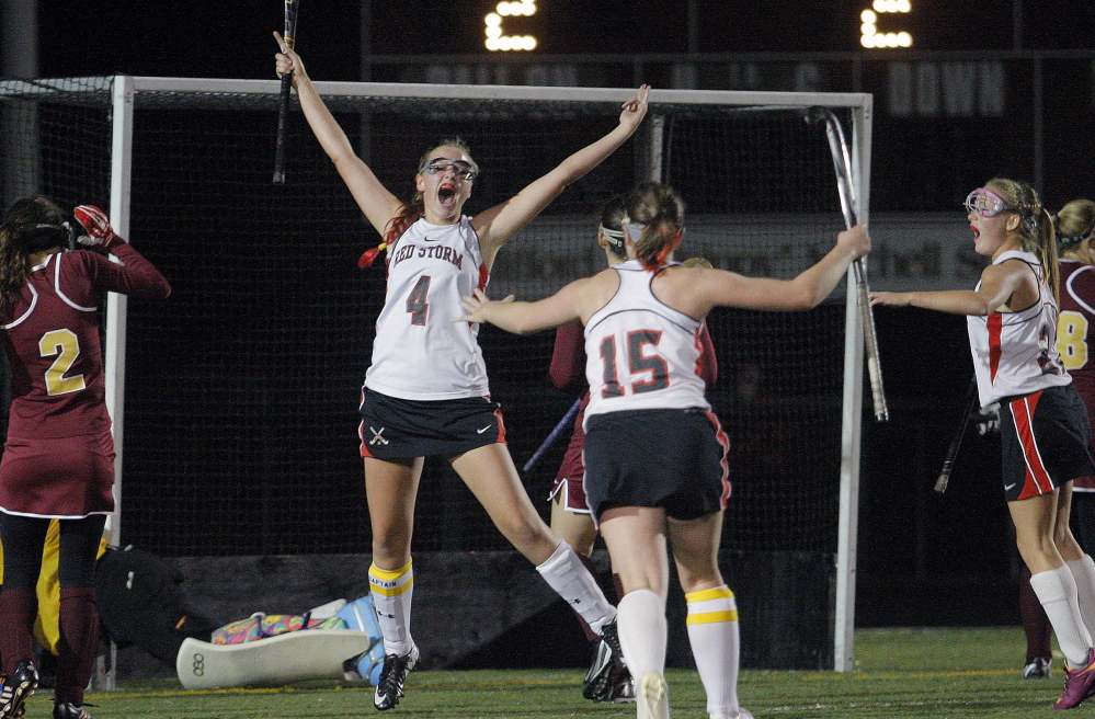 Scarborough’s Kristen Murray throws her arms in the air after scoring her team’s third goal in a 3-1 win over Thornton Academy on Tuesday night in a Western Class A field hockey semifinal at Scarborough. Celebrating with Murray are Abby Walker, center, and Ashley Levesque, right, as Thornton defender Dorina Sirois, left, looks on. The unbeaten Red Storm host the regional final Thursday.