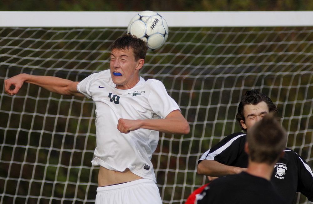 PORTLAND, ME - OCTOBER 27: Waynflete's Christian Brooks heads the ball in front of the Waynflete goal as Kyle Welsh of Saint Dom's tries to defend during a boys soccer playoff quarter final, Tuesday, October 27, 2014. (Photo by Gabe Souza/Staff Photographer)
