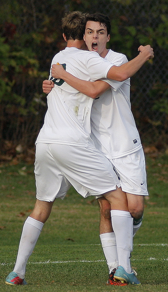 PORTLAND, ME - OCTOBER 27: Clancy Mitchell of Waynflete, at right, lets out a yell as he is hugged by his teammate Christian Brooks after Mitchell scored the second goal of the game for Waynflete vs. Saint Dom's during a boys soccer playoff quarter final, Tuesday, October 27, 2014. (Photo by Gabe Souza/Staff Photographer)
