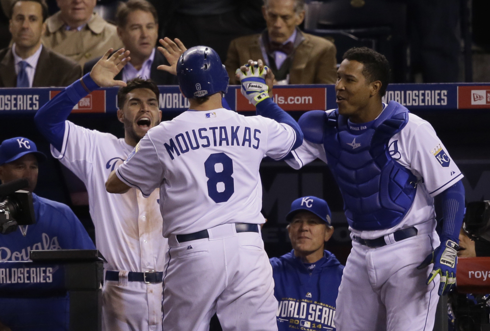 Kansas City’s Mike Moustakas celebrates with his teammates after hitting a solo home run in the seventh inning of Game 6 of the World Series on Tuesday night in Kansas City. The Royals forced a Game 7 with a 10-0 win.