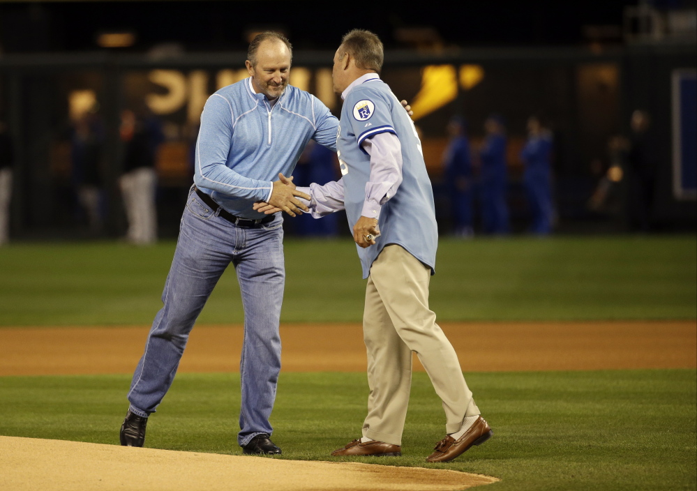 Former Kansas City Royals’ Bret Saberhagen, left, and George Brett shake hands before Game 3 of the American League baseball championship series against the Baltimore Orioles  in Kansas City, Mo., this month.