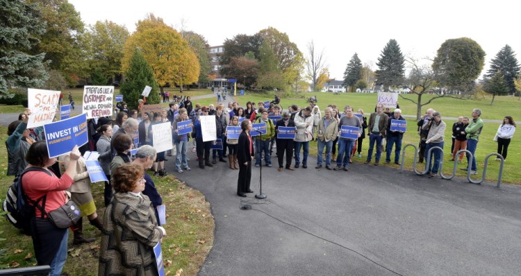 Economics professor Rachel Bouvier joins a rally near Payson Smith Hall on the Portland campus of the University of Southern Maine on Wednesday. The cuts are part of a plan to close a $16 million budget gap in the next fiscal year.