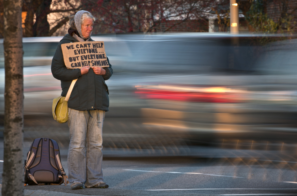 A homeless woman panhandles in Portland. The longterm growth of homelessness in the city has been visible in recent years.
