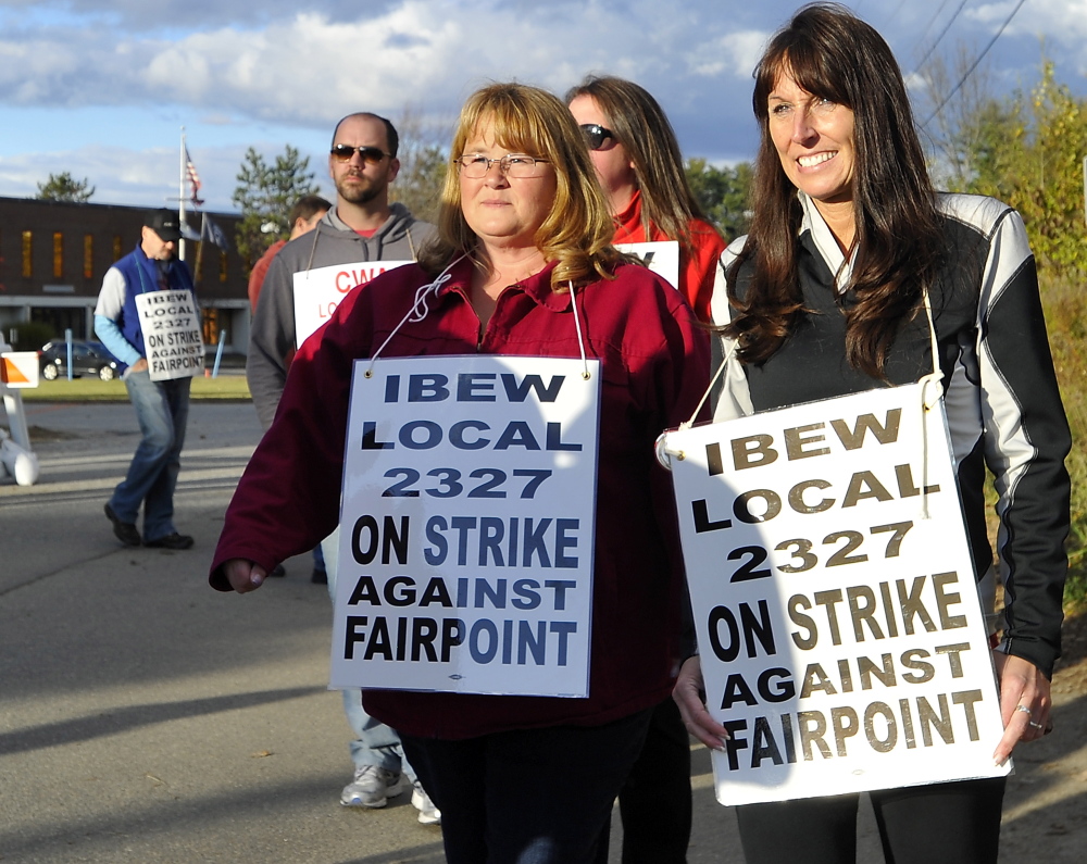 Striking workers picket outside FairPoint offices in Portland in October. The two sides are heading back to bargaining, although a date has not yet been set.