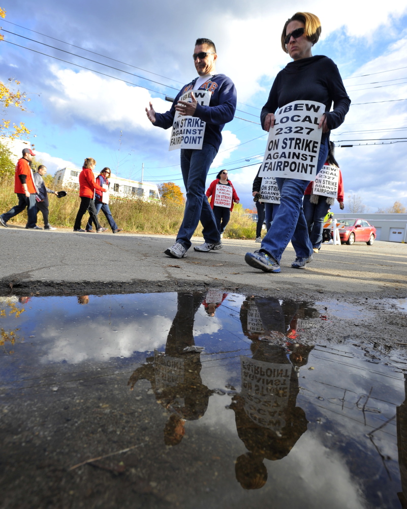 FairPoint strikers walk the picket line Thursday outside company offices on Davis Farm Road in Portland. Roughly 800 workers in Maine went on strike at midnight Oct. 16 along with 1,200 FairPoint employees in Vermont and New Hampshire. The company has asked for $700 million in contract concessions and the unions have countered with $200 million in benefit cuts.