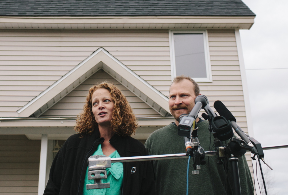 Kaci Hickox and Ted Wilbur hold a news conference outside their home in Fort Kent on Friday. Hickox said she hoped Wilbur would make her favorite sushi dish Friday and they would watch Halloween horror movies in an attempt to return to a normal life.