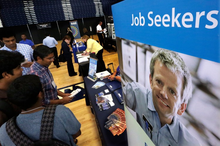 Students attend The Foot in the Door Career Fair at the University of Illinois in Springfield, Ill., last week. September's job gains mean that more Americans are earning paychecks and can spend more. The Associated Press