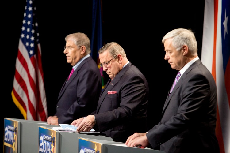 Maine's three candidates for governor, from left independent Eliot Cutler, Republican Gov. Paul LePage and Democratic U.S. Rep. Mike Michaud, look over their notes as they prepare for Tuesday night's debate at WMTW-TV's studio in Auburn.