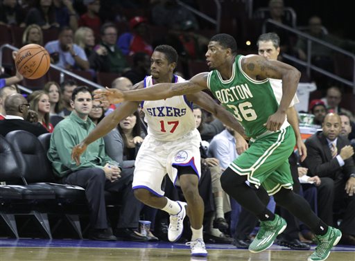 Celtics point guard Marcus Smart and 76ers point guard Casper Ware chase a loose ball in the first half Oct. 16 in Philadelphia. The Associated Press
