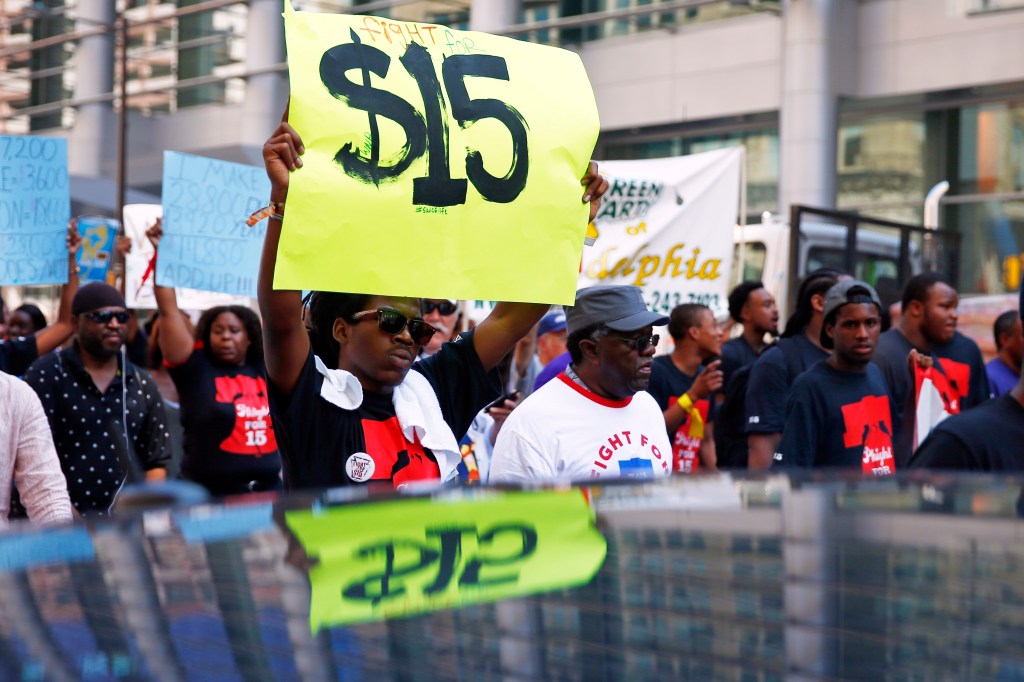 Fast-food workers seeking higher pay are battling a tough fact of life: Hiring is healthy but wages are stagnant. And no one is sure when pay increases will come.