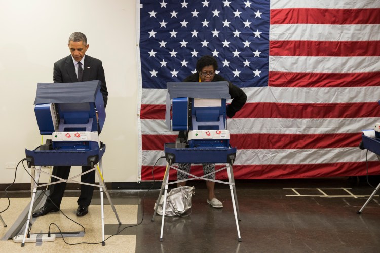 President Barack Obama casts a ballot at the Dr. Martin Luther King Community Service Center while participating in early voting on Monday in Chicago. Obama took a break from campaigning for Gov. Pat Quinn, D-Ill., to cast the ballot for the 2014 midterm elections. The Associated Press