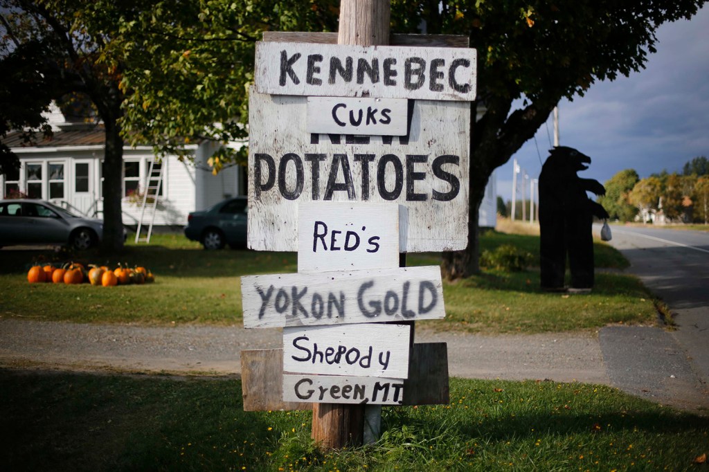 Signs advertise some of the varieties of potatoes for sale outside a farm near Houlton. Farm income, a small component of personal income, increased nearly 60 percent in Aroostook County in 2013.