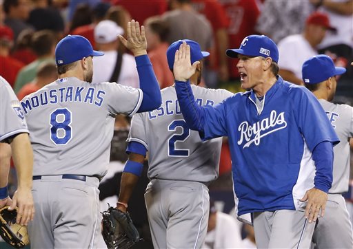 Kansas City Royals manager Ned Yost, right, celebrates with Mike Moustakas after the Royals' 3-2 win over the Los Angeles Angels in 11 innings in Game 1 of baseball's AL Division Series in Anaheim, Calif., Thursday. Moustakas hit a home run in the 11th inning. The Associated Press