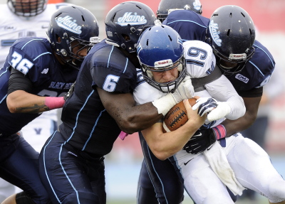 Maine defenders bring down Villanova quarterback John Robertson for a sack late in the game Oct. 4 at Alfond Stadium in Orono. Maine's defense has been solid most of the season but hasn't been able to make the game-turning play when the chance arises. Gabe Souza/Staff Photographer