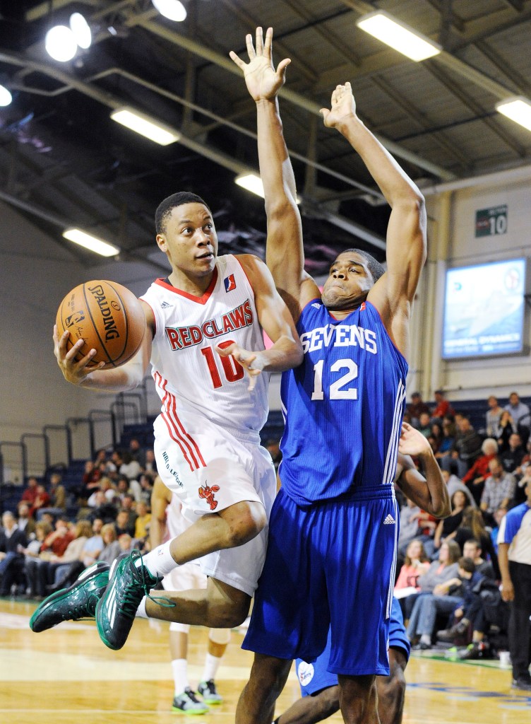 Maine’s Tim Frazier sdrives the lane against Delaware’s Ronald Roberts Jr. during the Red Claws’ 120-102 win Sunday. John Ewing/Staff Photographer