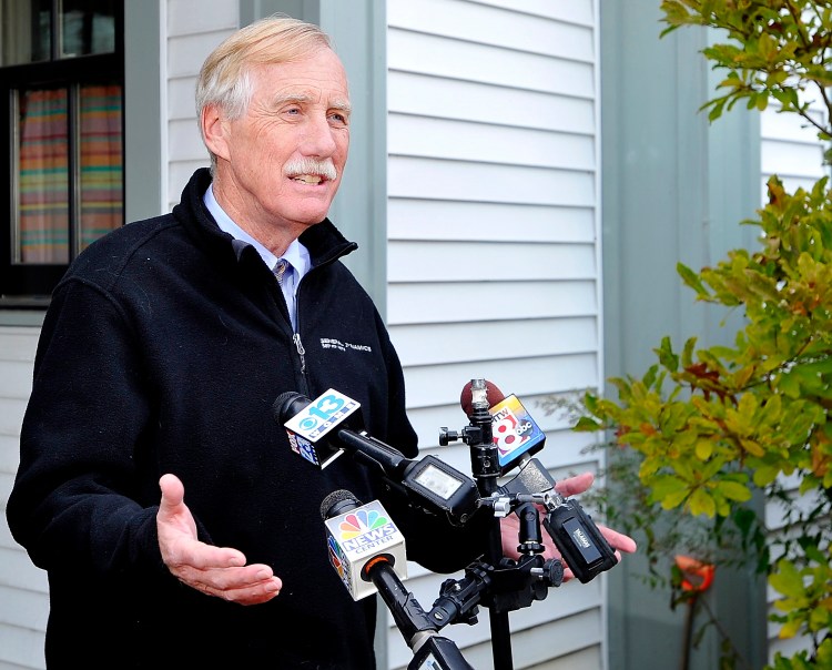 U.S. Sen. Angus King speaks outside his home in Brunswick on Wednesday to announce he will caucus with the Democratic Party.