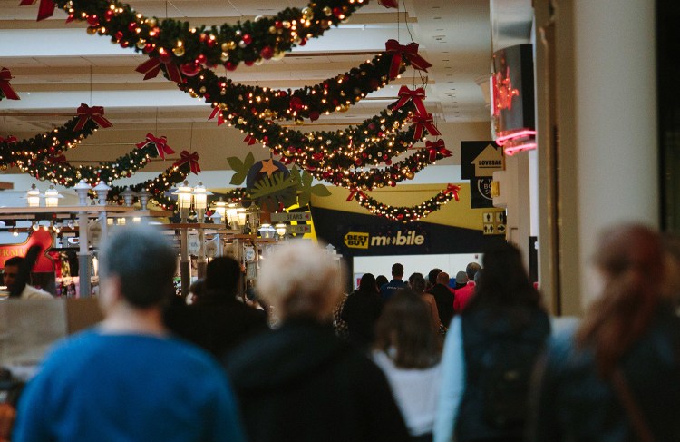 Shoppers walk through a busy area at the Maine Mall in South Portland on Tuesday. While many malls in America are slumping because of Internet sales, the Maine Mall has kept a high occupancy rate.