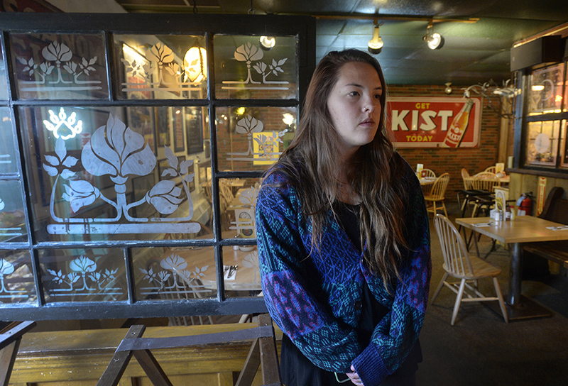  Lily Dickson, a friend and coworker of some of the victims in the fatal fire, speaks with a reporter at the Great Lost Bear Saturday. Shawn Patrick Ouellette/Staff Photographer
