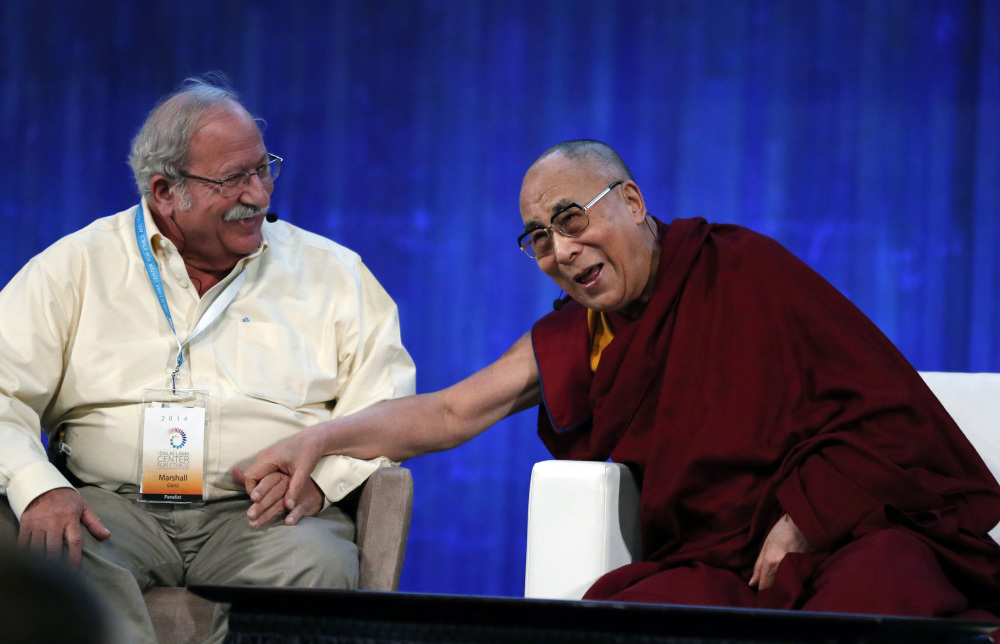 The Dalai Lama, Tibet’s spiritual leader, laughs with Harvard’s Kennedy School professor Marshall Ganz at the Massachusetts Institute of Technology in Cambridge on Friday.