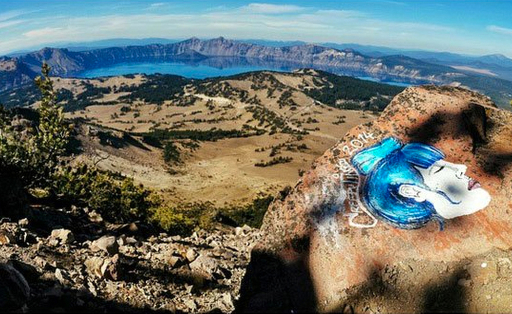 A rock painting on an overlook at Crater Lake National Park in Oregon is among several that managers have to deal with at parks across California, Colorado, Utah and Oregon.