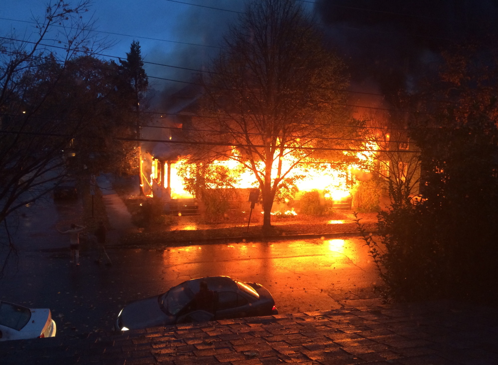 Flames engulf a Noyes Street apartment building in this photo taken shortly after the fire started around 7 a.m. Saturday. Witnesses said the fire may have originated on a porch, and investigators say they’ll try to determine if there are traces of an accelerant.