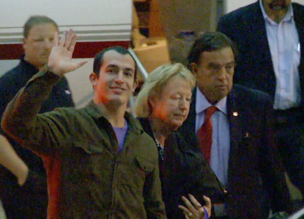 Marine Sgt. Andrew Tahmooressi waves after arriving in Miami on Saturday. Tahmooressi is back home after a Mexican judge ordered his release from jail, where he spent eight months for crossing the border with loaded guns.