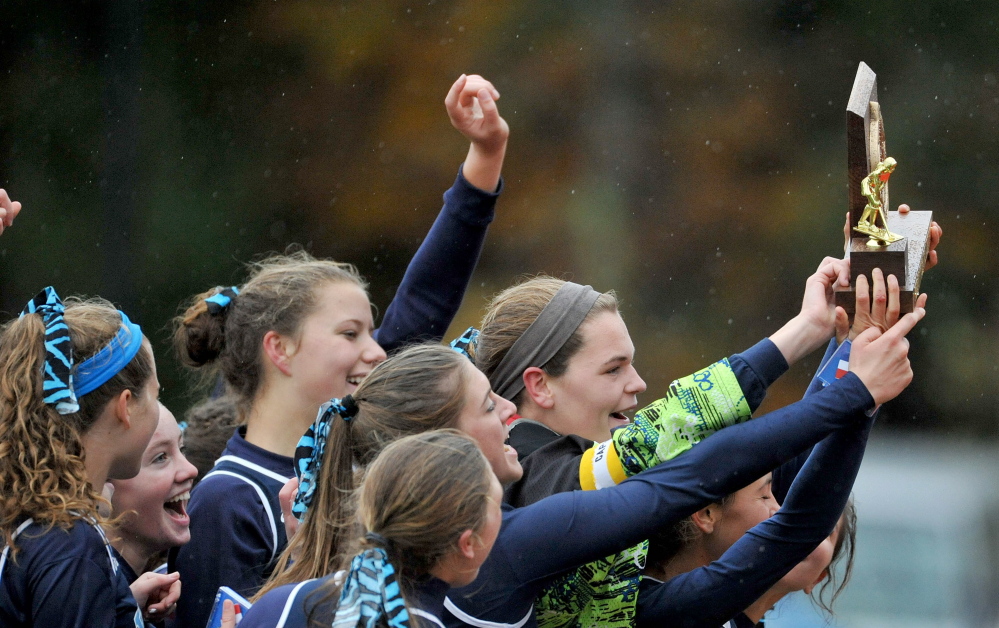 York celebrates the Class B field hockey championship Saturday with a 2-1 victory against Gardiner.