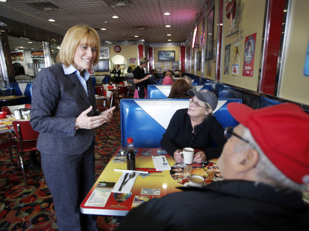 New Hampshire Gov. Maggie Hassan, a Democrat, talks with Mary and Rick Silva during a campaign stop at MaryAnn’s Diner in Derry, N.H. The name recognition hat comes with being the incumbent is a plus for her campaign.
