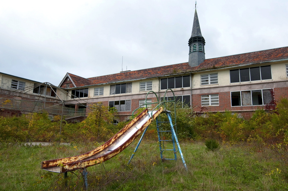 A rusty children’s slide remains on the property at the former Seaside tuberculosis sanatorium, in Waterford, Conn. The sanatorium was designed in 1913 by noted architect Cass Gilbert for children who suffered from tuberculosis.