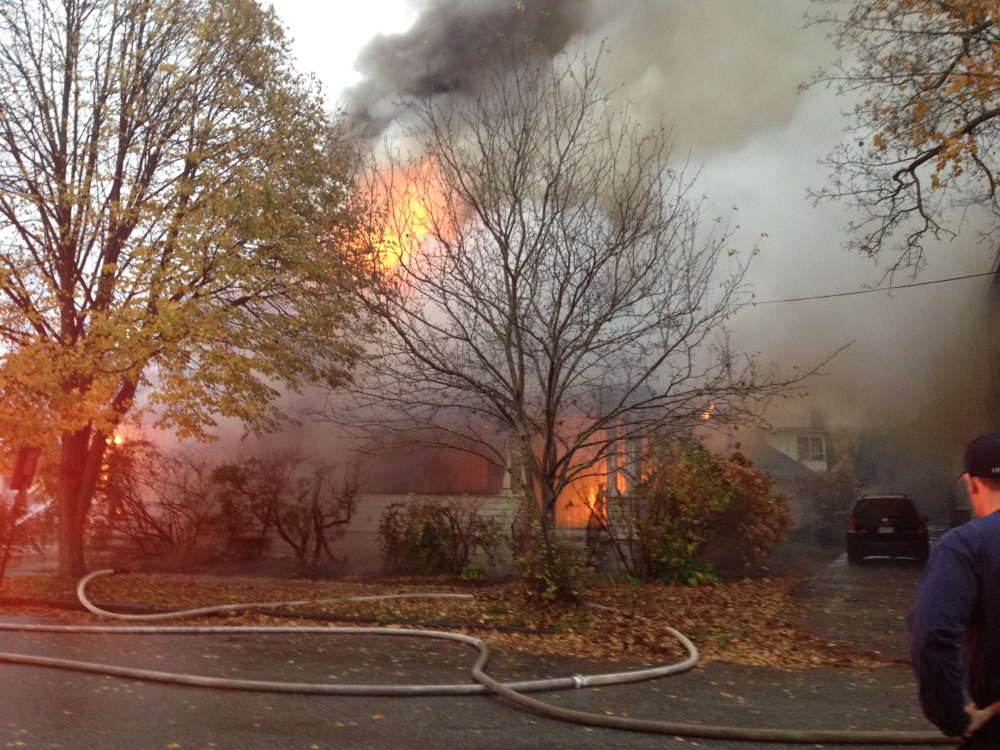 A fire rages at a house on Noyes Street in Portland on Saturday morning.