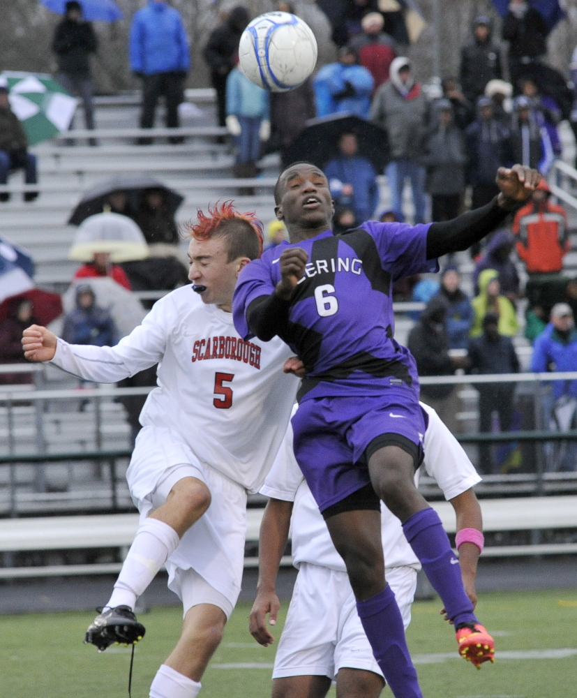 Hany Ramadan of Deering and Nick Lorello of Scarborough go for the ball Saturday during Scarborough’s 3-1 victory in a Western Class A boys’ soccer semifinal.
John Patriquin/ Staff Photographer