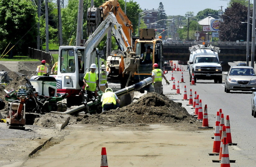 Contractors install a natural gas pipeline on College Avenue in Waterville in June. The Maine Public Utilities Commission voted last week to review three proposals to expand pipeline capacity in New England.