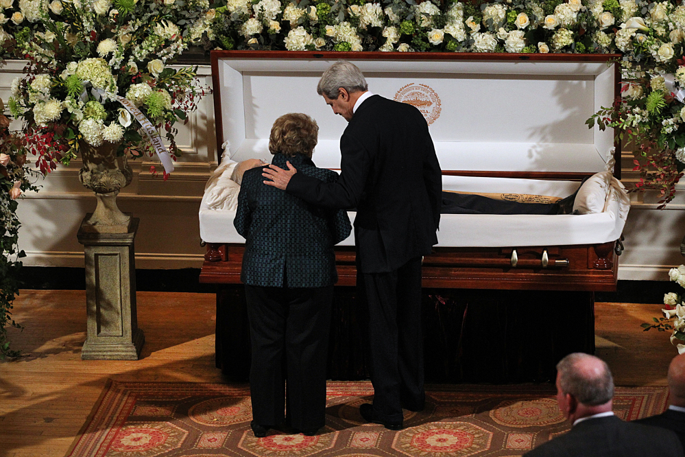 Secretary of State John Kerry and Angela Menino, widow of former Boston Mayor Tom Menino, stand at the casket as Menino lies in state at Faneuil Hall on Sunday. 
Suzanne Kreiter/The Boston Globe