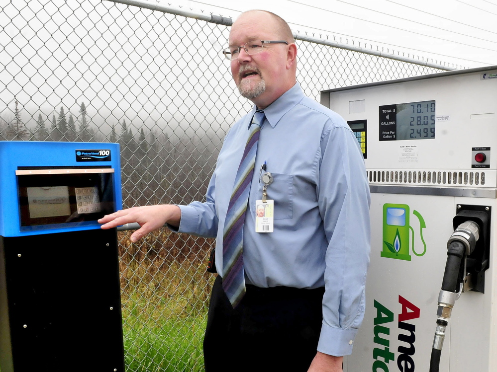 David Leavitt, director of support services for RSU 9 in Farmington, shows the meter system on a propane pump that will be used to fuel several buses at the bus garage.
