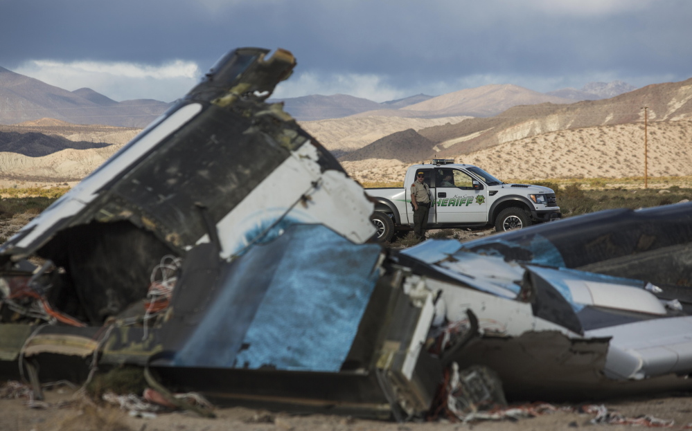 Law enforcement officers stand watch Saturday near the wreckage of SpaceShipTwo, a Virgin Galactic space tourism rocket that had exploded and crashed in Mojave, Calif. a day earlier, killing one of the pilots aboard.